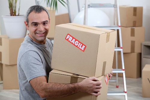 Moving team handling furniture safely during a North End van removal