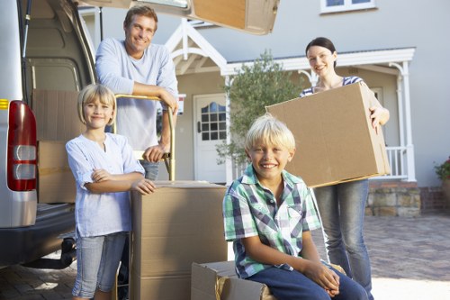 Professional movers carrying boxes in a North End property