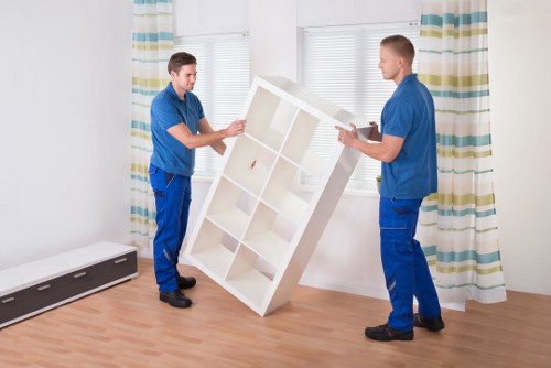 Movers carrying furniture through a North End property entrance